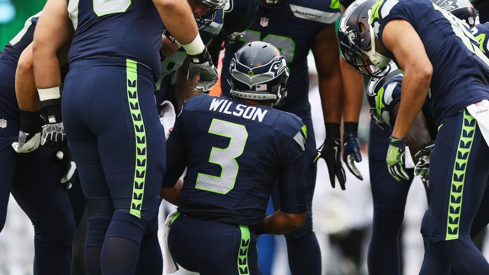 The Seattle Seahawks huddle during an NFL football game against