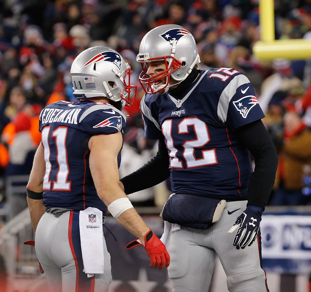 FOXBORO, MA - JANUARY 14: Julian Edelman #11 talks to Tom Brady #12 of the New England Patriots in the second half against…