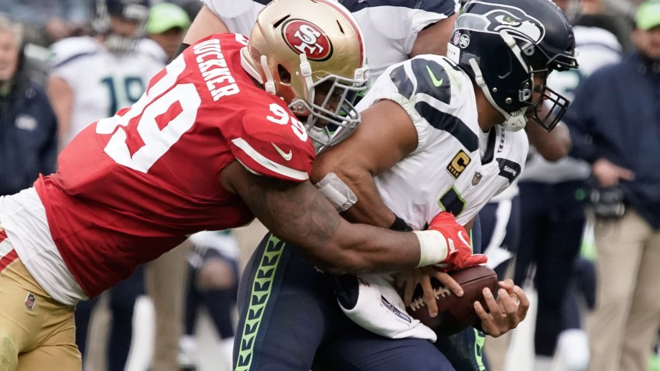 Denver Broncos quarterback Russell Wilson (3) is tackled by Indianapolis  Colts defensive tackle DeForest Buckner (99)