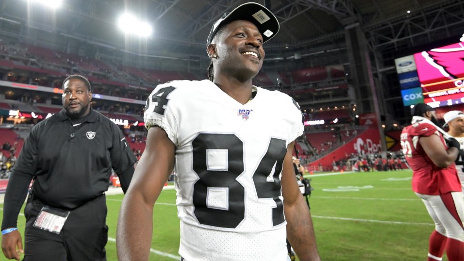 Oakland Raiders wide receiver Antonio Brown (84) puts on his helmet prior  to an NFL football ga …