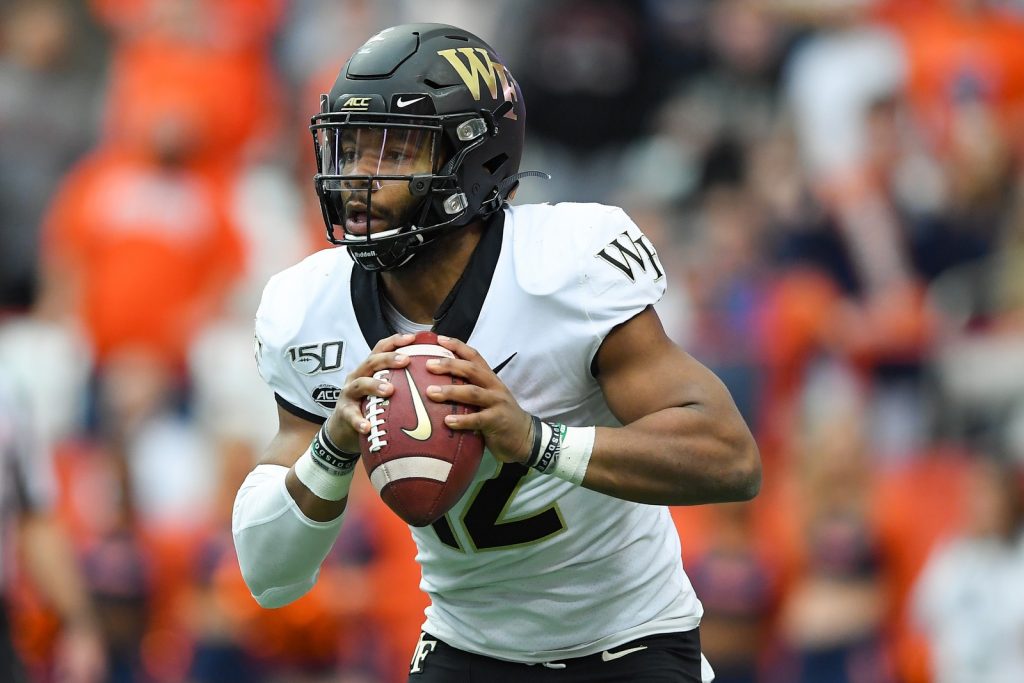 Wake Forest Demon Deacons quarterback Jamie Newman (12) runs with the ball against the Syracuse Orange during the first quarter at the Carrier Dome. Mandatory Credit: Rich Barnes-USA TODAY Sports