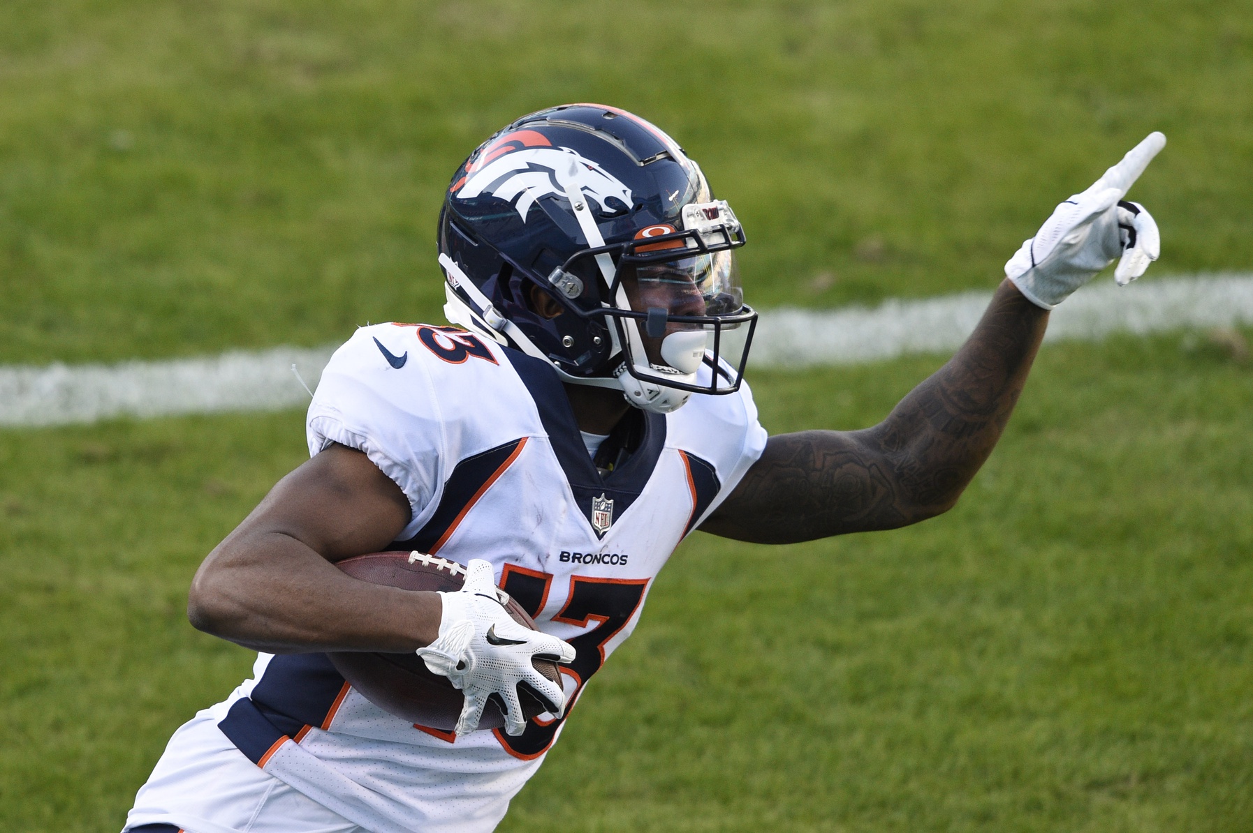 Denver Broncos cornerback Michael Ojemudia (13) runs a play