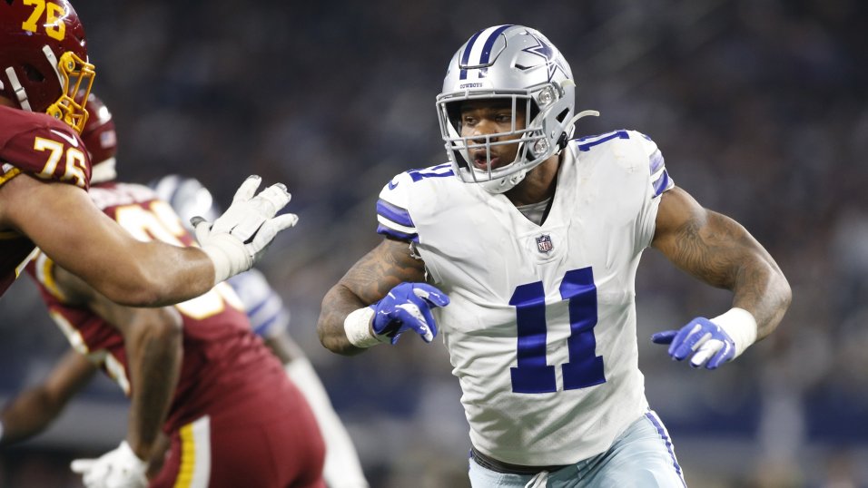 Dallas Cowboys linebacker Micah Parsons (11) is tackled by Los Angeles  Chargers offensive tackl …