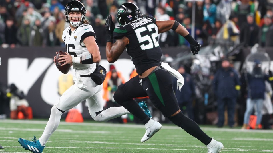 Dec 22, 2022; East Rutherford, New Jersey, USA; Jacksonville Jaguars quarterback Trevor Lawrence (16) looks to pass while being pursued by New York Jets defensive end Jermaine Johnson (52) during the second half at MetLife Stadium. Mandatory Credit: Ed Mulholland-USA TODAY Sports. Green Bay Packers