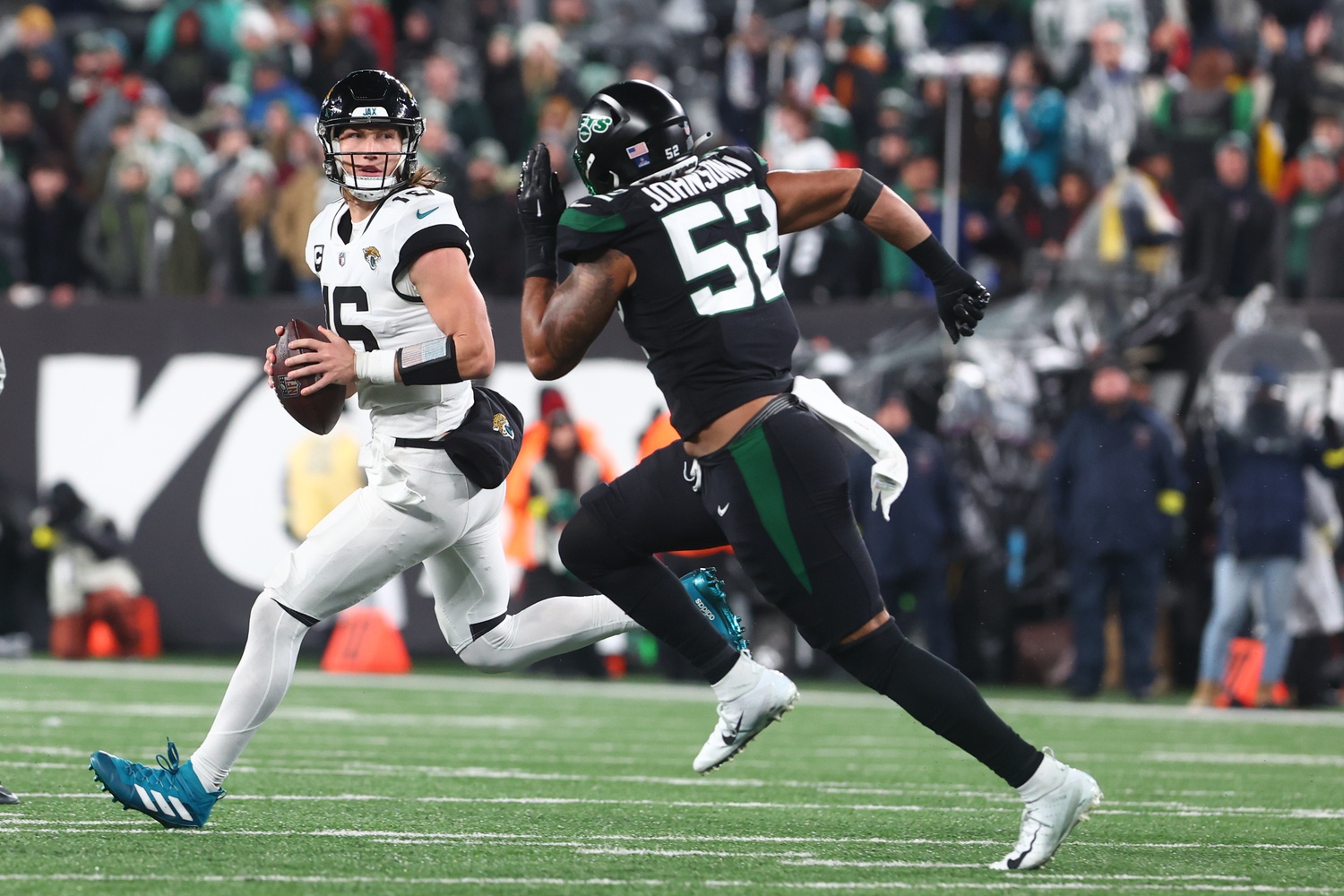 Dec 22, 2022; East Rutherford, New Jersey, USA; Jacksonville Jaguars quarterback Trevor Lawrence (16) looks to pass while being pursued by New York Jets defensive end Jermaine Johnson (52) during the second half at MetLife Stadium. Mandatory Credit: Ed Mulholland-USA TODAY Sports. Green Bay Packers